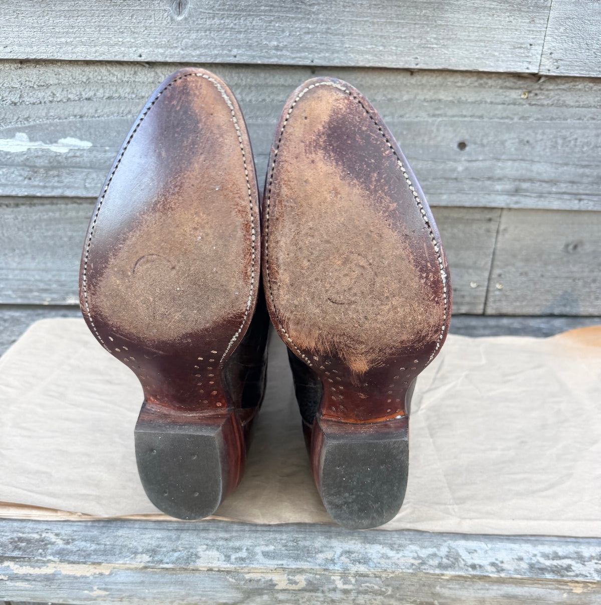 Leather soles and heel caps showing wear on pre-owned Sheplers boots